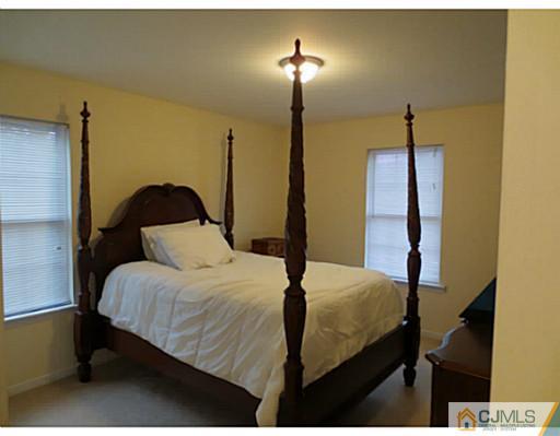 414 New Market Road Dunellen, NJ 08812 - Photo 18 of 25 a bedroom with a bed and a night stand