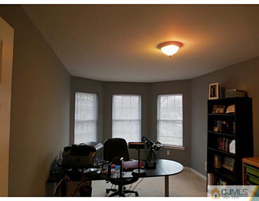 414 New Market Road Dunellen, NJ 08812 - Photo 20 of 25 a living room with furniture and two lamps