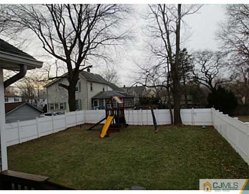 414 New Market Road Dunellen, NJ 08812 - Photo 3 of 25 a view of a backyard with a slide