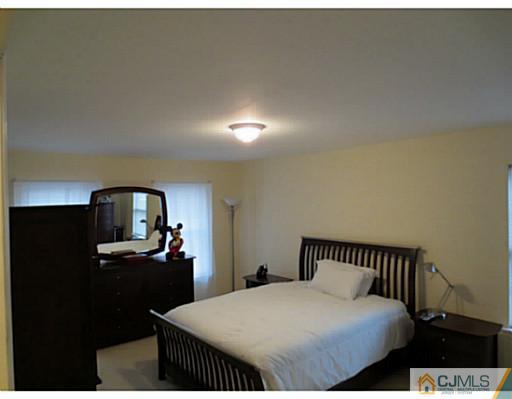 414 New Market Road Dunellen, NJ 08812 - Photo 25 of 25 a bedroom with a bed and a dresser