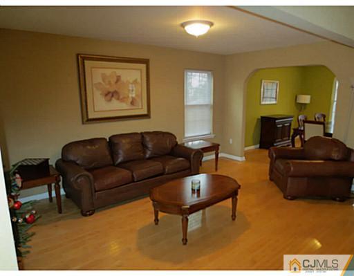 414 New Market Road Dunellen, NJ 08812 - Photo 5 of 25 a living room with furniture and a flat screen tv