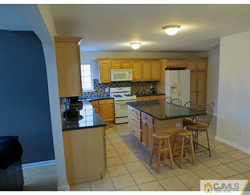 414 New Market Road Dunellen, NJ 08812 - Photo 7 of 25 a kitchen with a sink and cabinets