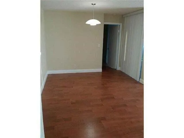 a view of empty room with floor to ceiling window