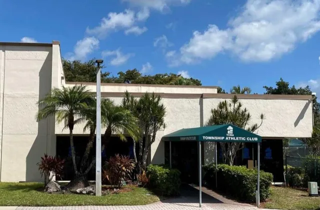 a patio with a table and chairs under an umbrella