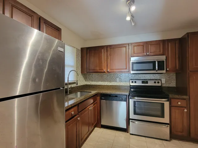 a kitchen with a sink and stainless steel appliances