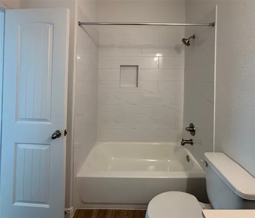 a view of a bathroom with wooden floor a sink and a bathroom