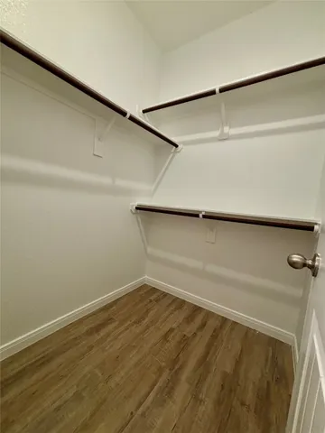 a view of a balcony with wooden floor & fence