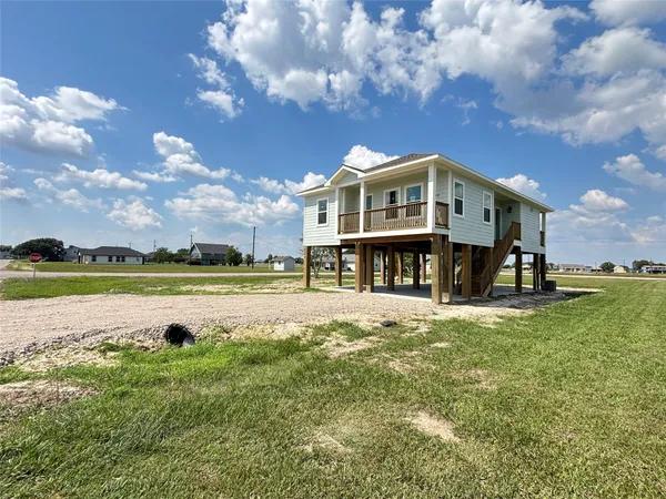 a front view of a house with swimming pool and a yard