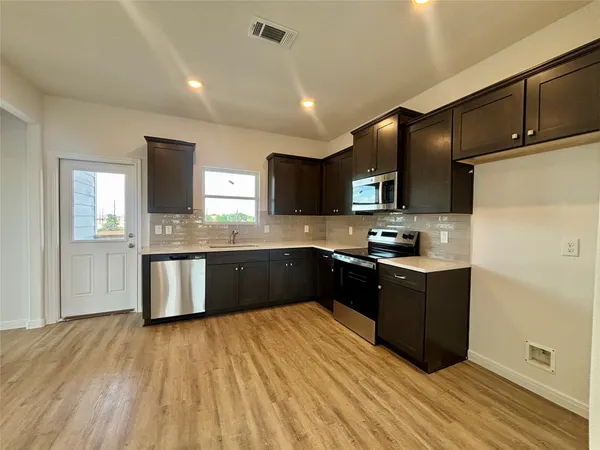 a kitchen with a sink and a microwave