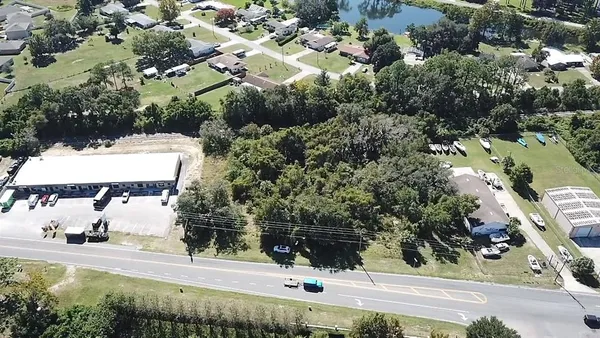 an aerial view of a house with yard