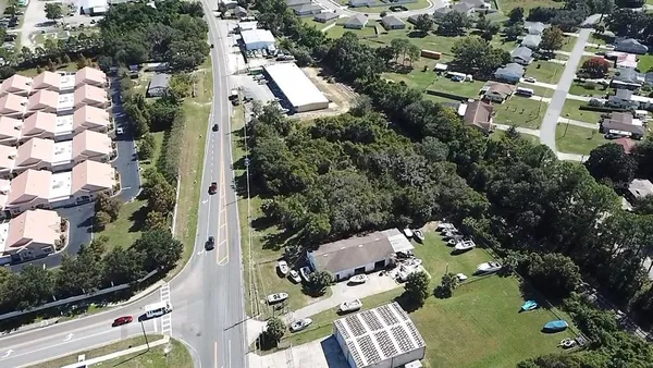an aerial view of multiple houses with yard