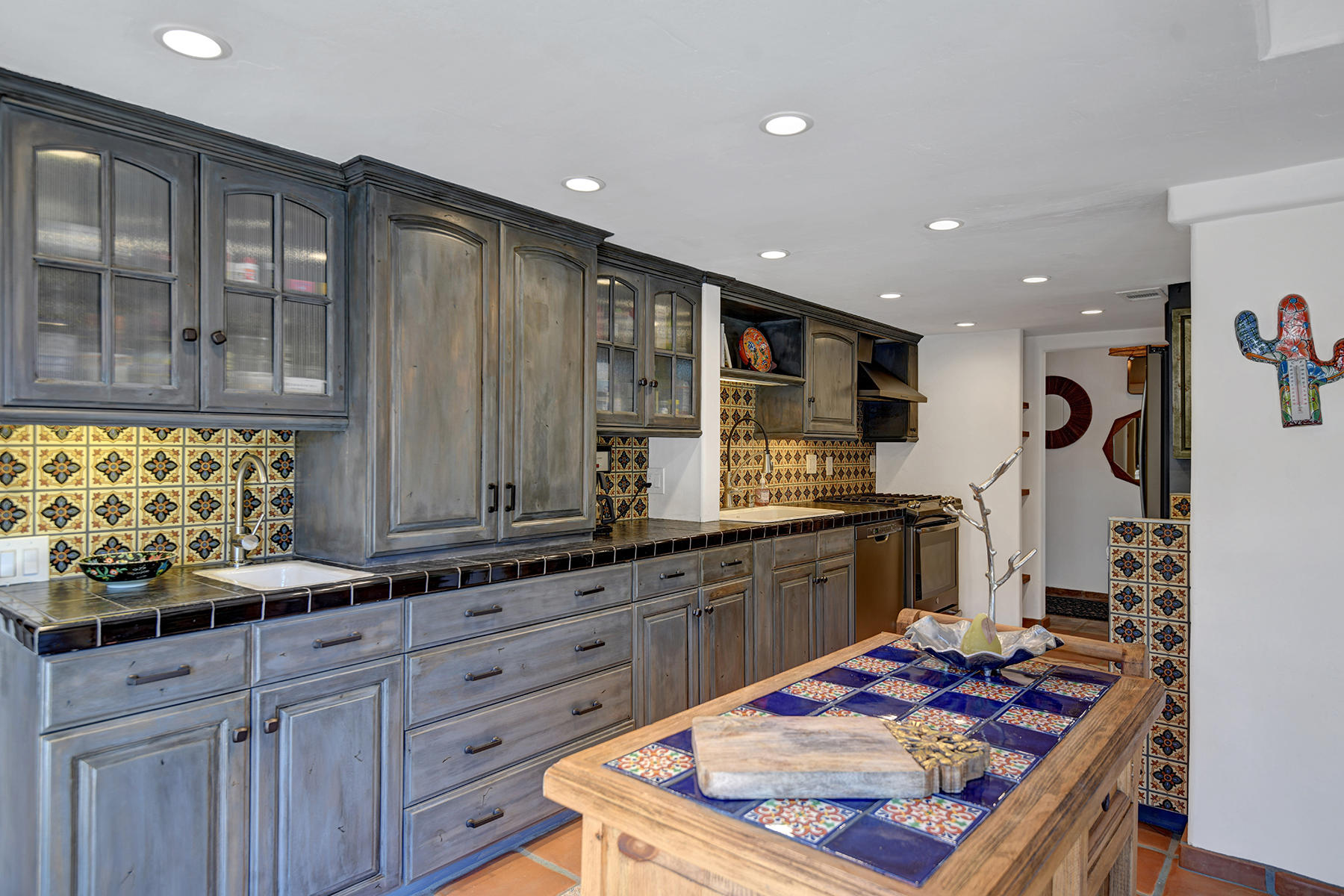 71677 Tunis Road Rancho Mirage, CA 92270 - Photo 11 of 37 a kitchen with stainless steel appliances granite countertop a sink stove and cabinets