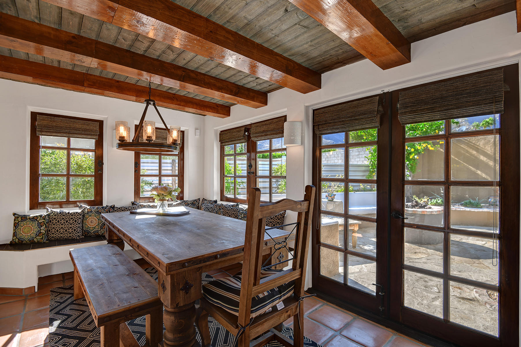 71677 Tunis Road Rancho Mirage, CA 92270 - Photo 14 of 37 a dining room with furniture a chandelier and wooden floor