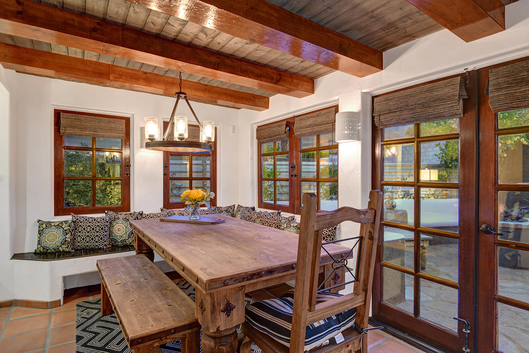 71677 Tunis Road Rancho Mirage, CA 92270 - Photo 15 of 37 a view of a dining room with furniture large windows and wooden floor