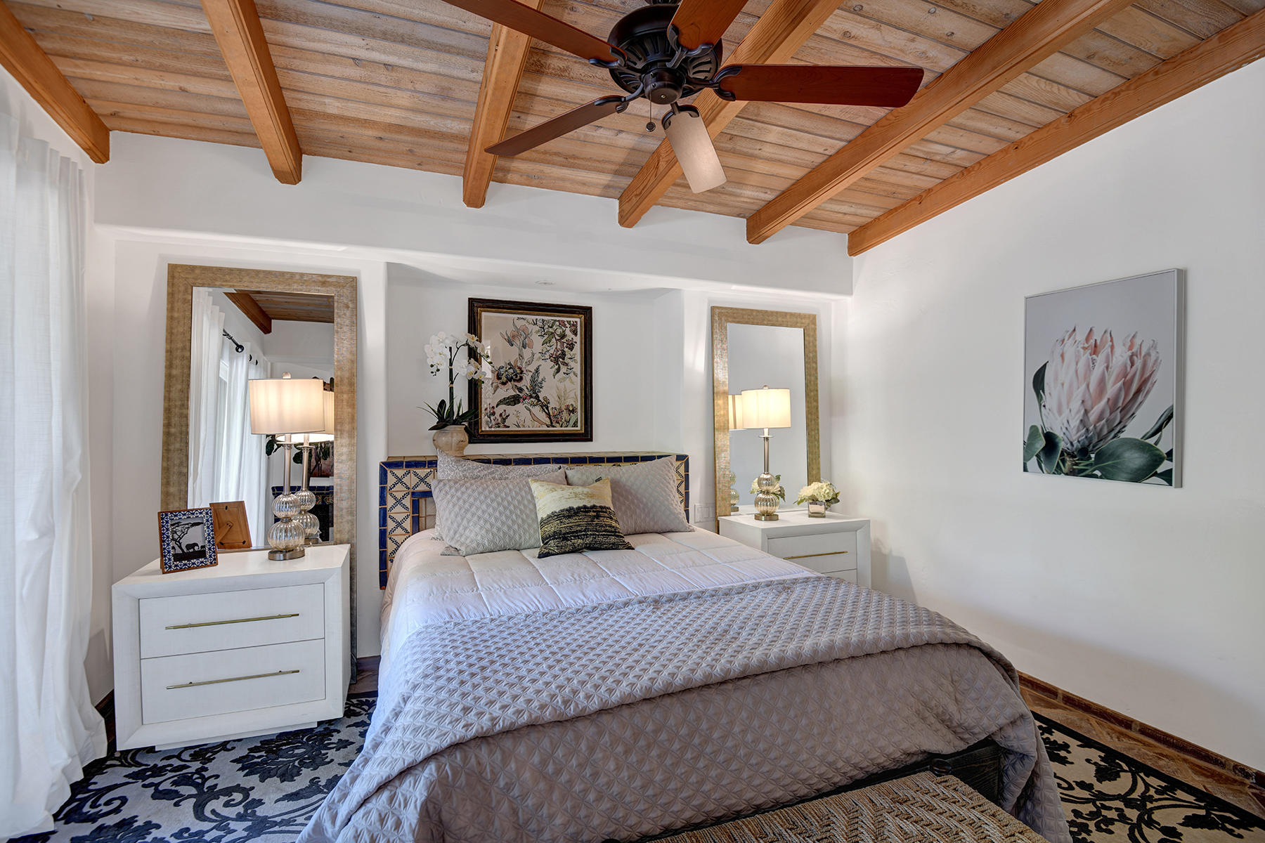 71677 Tunis Road Rancho Mirage, CA 92270 - Photo 17 of 37 a bedroom with a large bed and a chandelier