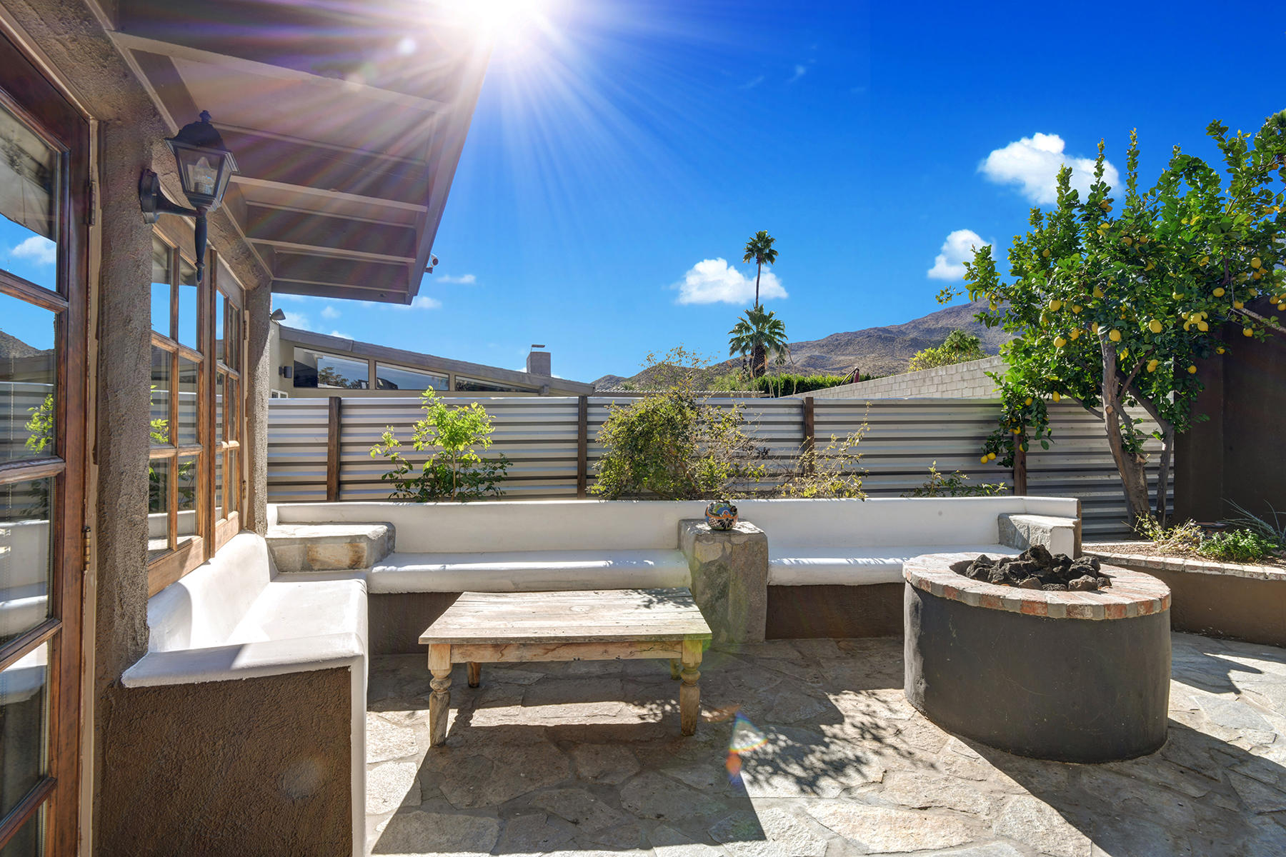 71677 Tunis Road Rancho Mirage, CA 92270 - Photo 29 of 37 a view of a patio with couches and potted plants