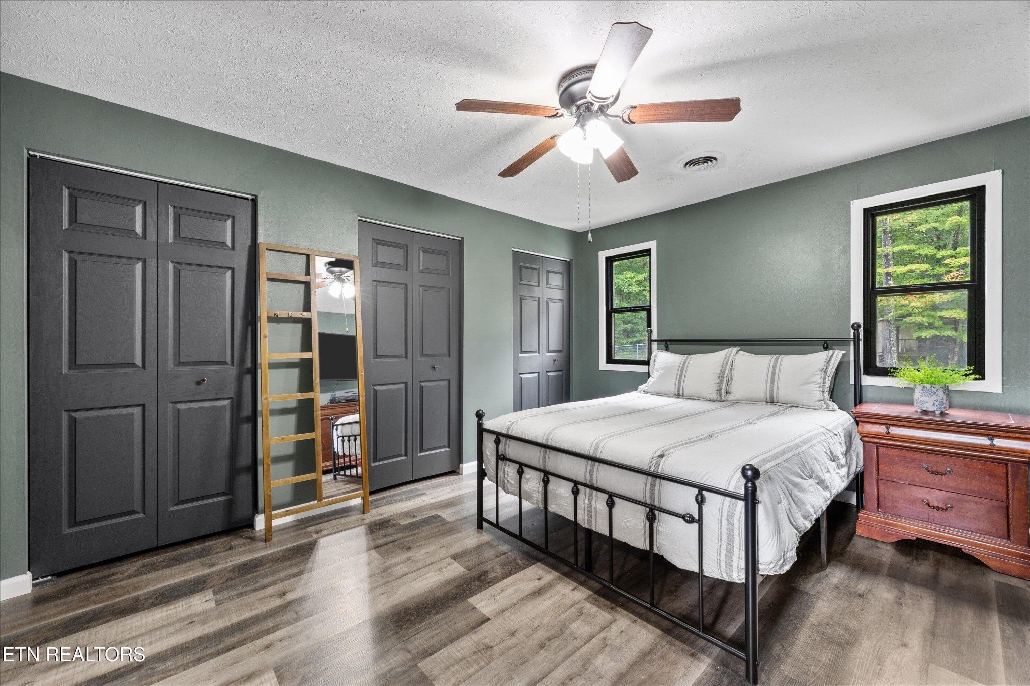 484 HC Smith Drive Oneida, TN 37841 - Photo 16 of 35 a bedroom with a large bed a chandelier and closet