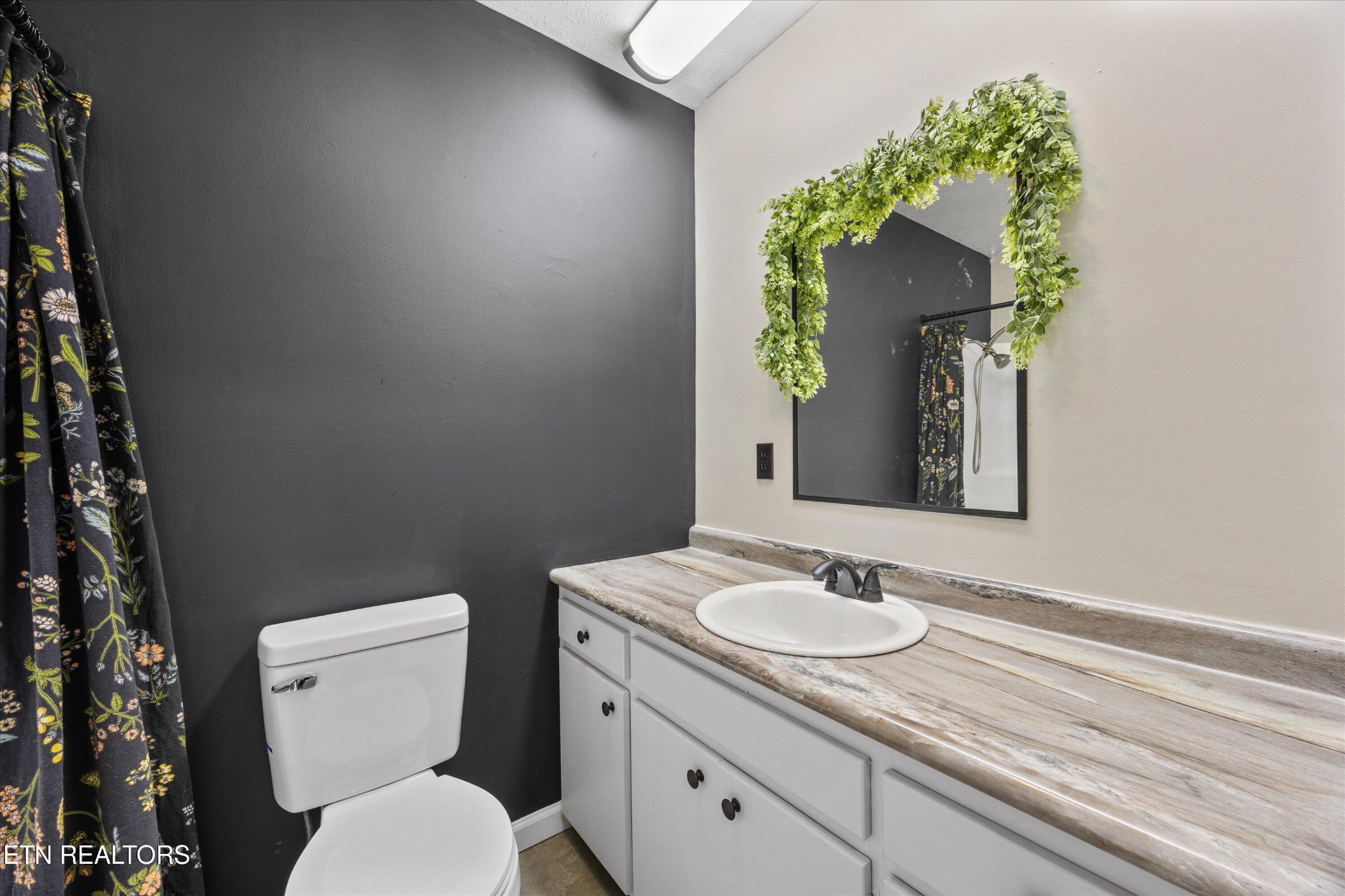 484 HC Smith Drive Oneida, TN 37841 - Photo 20 of 35 a bathroom with a toilet sink and mirror