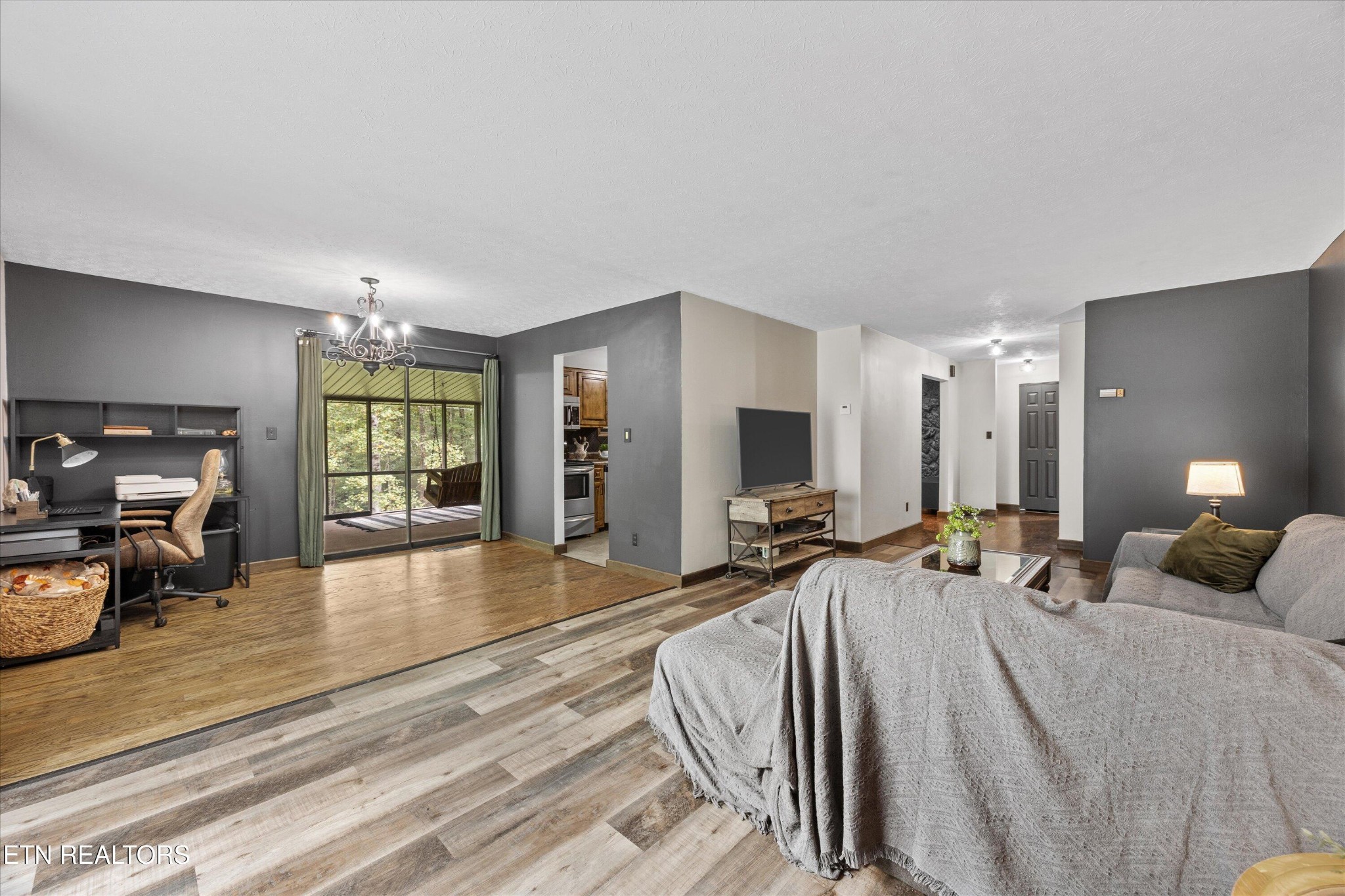 484 HC Smith Drive Oneida, TN 37841 - Photo 7 of 35 a spacious bedroom with a bed a couch and large windows