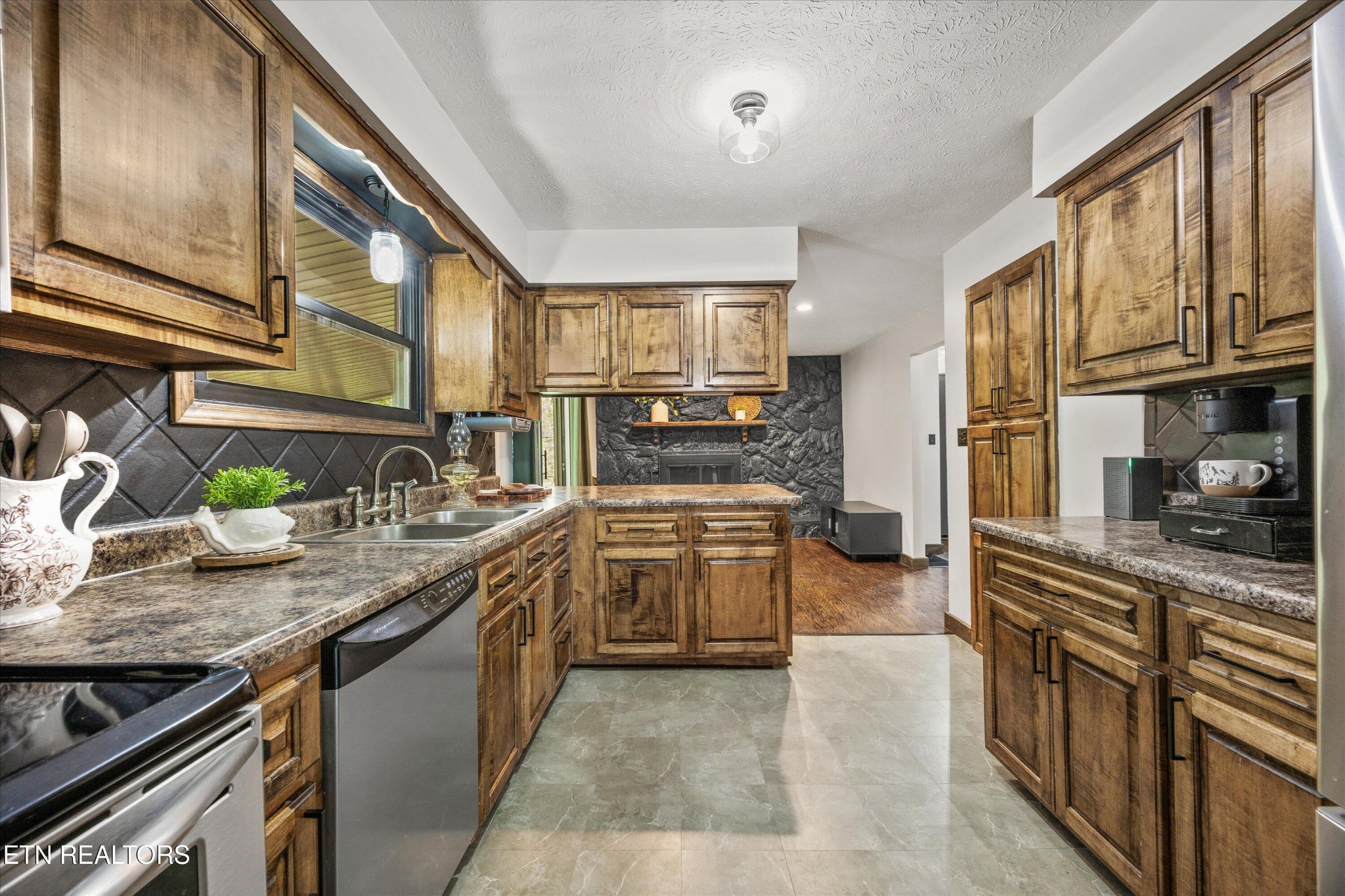 484 HC Smith Drive Oneida, TN 37841 - Photo 9 of 35 a kitchen with stainless steel appliances granite countertop lots of counter top space and wooden floor