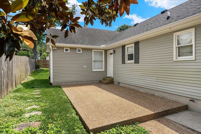 a view of backyard of house with green space