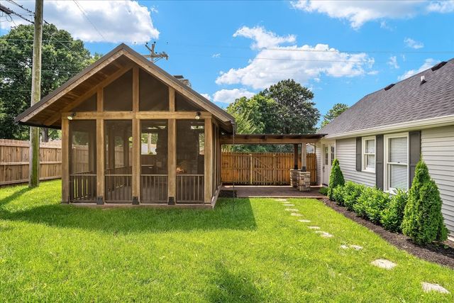 a view of a house with a yard and plants