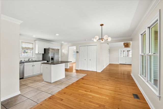 a view of kitchen with stainless steel appliances refrigerator stove microwave and cabinets