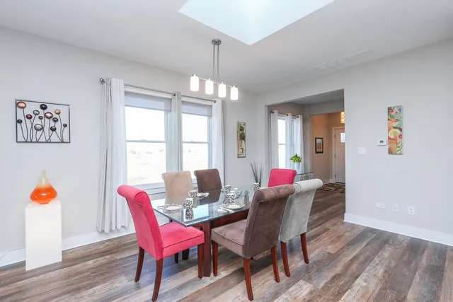 a view of a dining room with furniture and chandelier