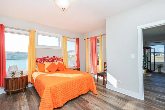 a view of a hallway with wooden floor and glass door