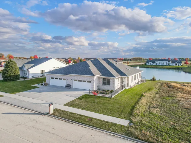 a view of a house with a big yard and large trees