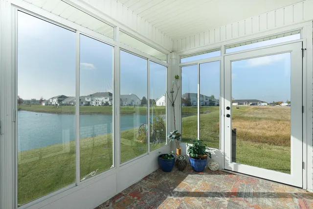 an aerial view of a house with outdoor space lake view and boat