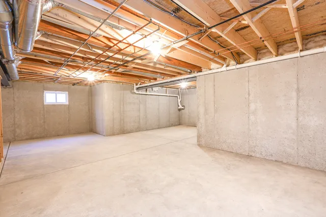 an aerial view of a house with a garden and lake view