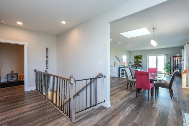 a living room with furniture kitchen view and a chandelier