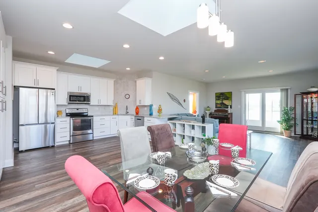 a kitchen with white cabinets and stainless steel appliances