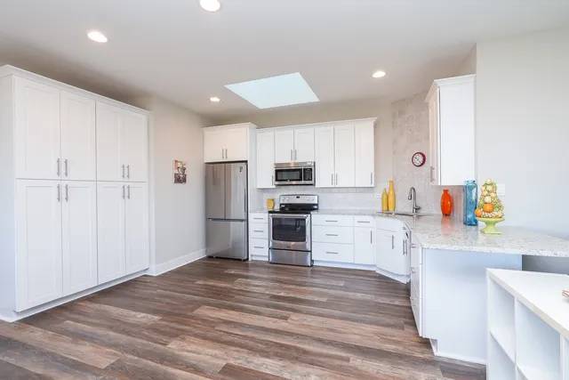 a view of a dining room with furniture and chandelier