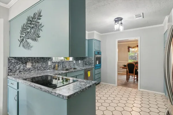 a kitchen with a sink window and cabinets
