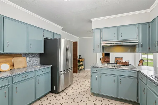 a kitchen with stainless steel appliances granite countertop a refrigerator and a sink