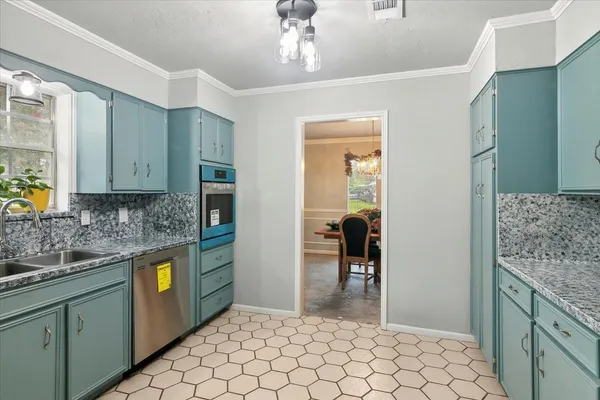 a dining room with furniture and chandelier