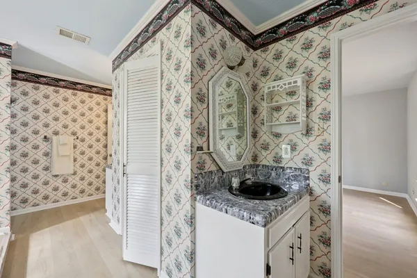 a bathroom with a sink a mirror and a shower