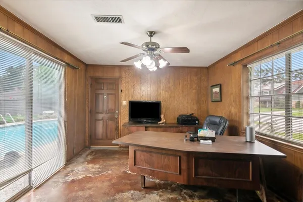 a living room with furniture a chandelier and a dining table