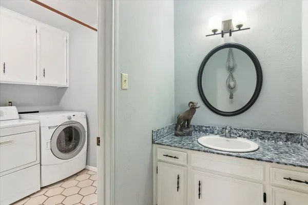 a view of washer and dryer with kitchen in the background