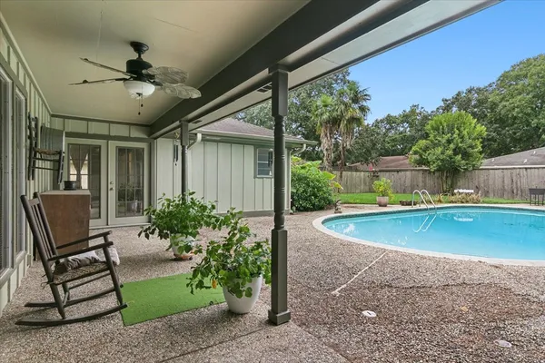 a view of house with outdoor space and swimming pool