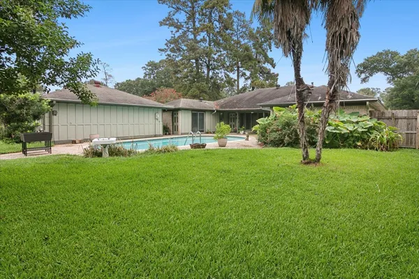 a front view of house with yard and green space