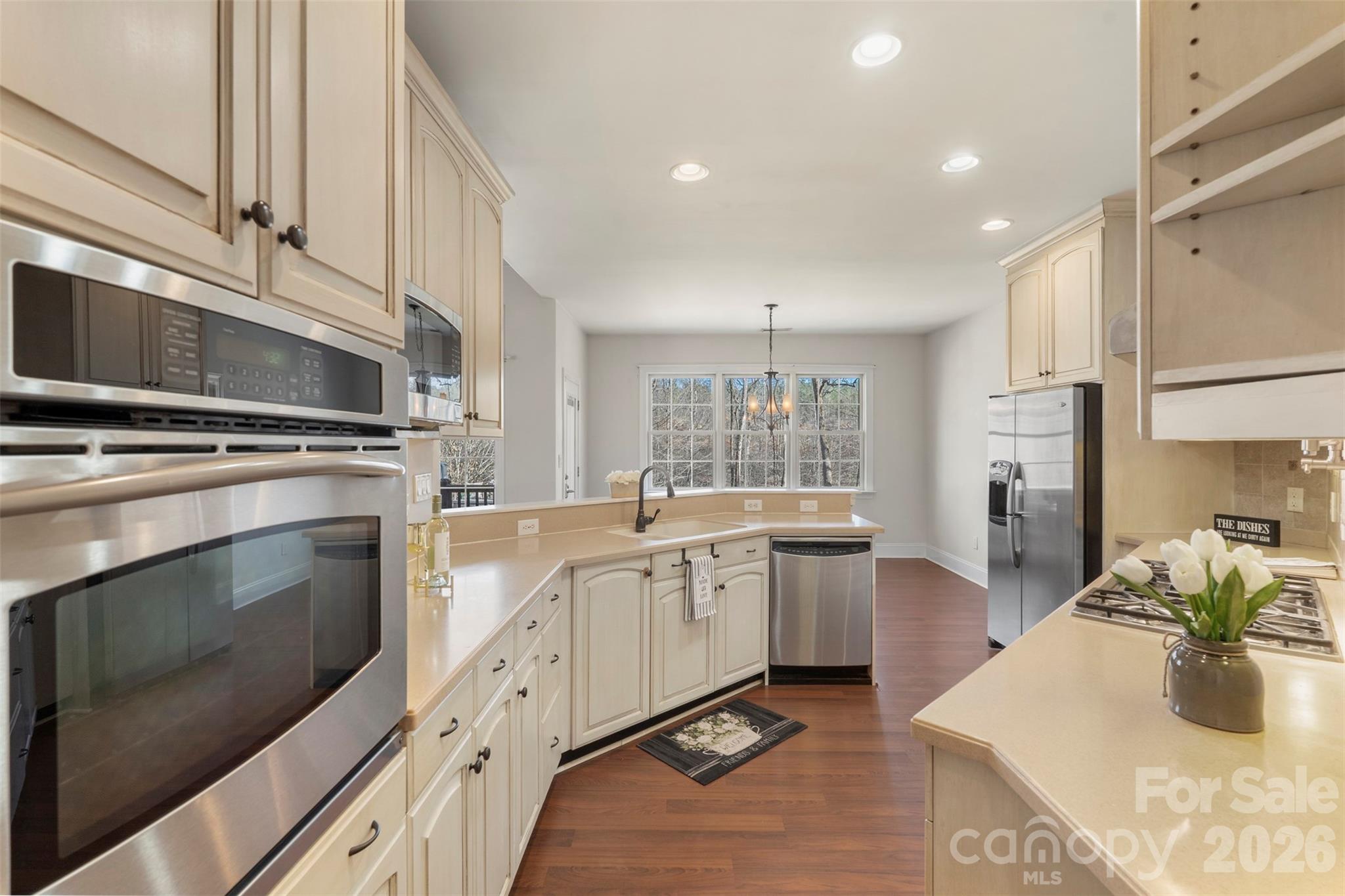 12711 Moores Chapel Road Charlotte, NC 28214 - Photo 13 of 48 a kitchen with stainless steel appliances granite countertop a stove a sink and a microwave