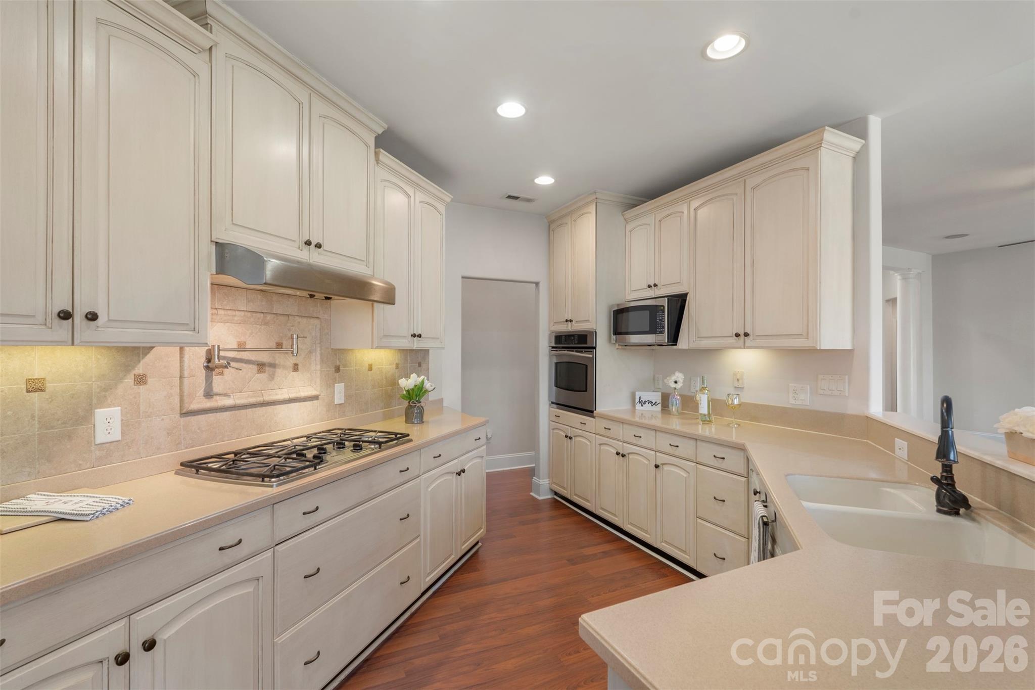 12711 Moores Chapel Road Charlotte, NC 28214 - Photo 14 of 48 a kitchen with stainless steel appliances granite countertop a stove a sink and a refrigerator