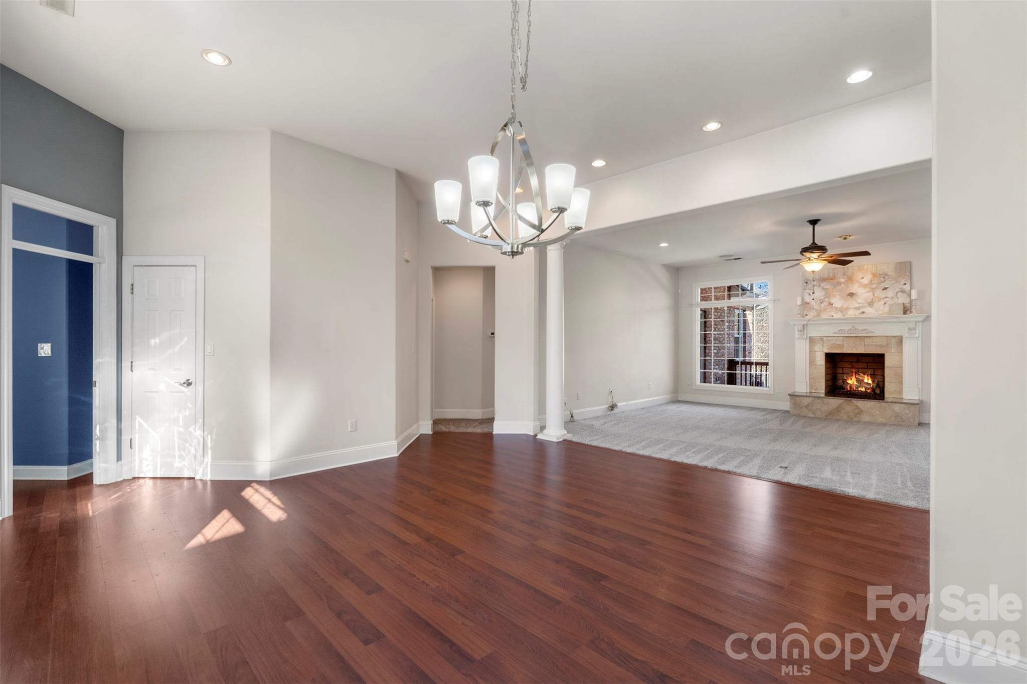 12711 Moores Chapel Road Charlotte, NC 28214 - Photo 17 of 48 a view of an empty room with wooden floor and a fireplace
