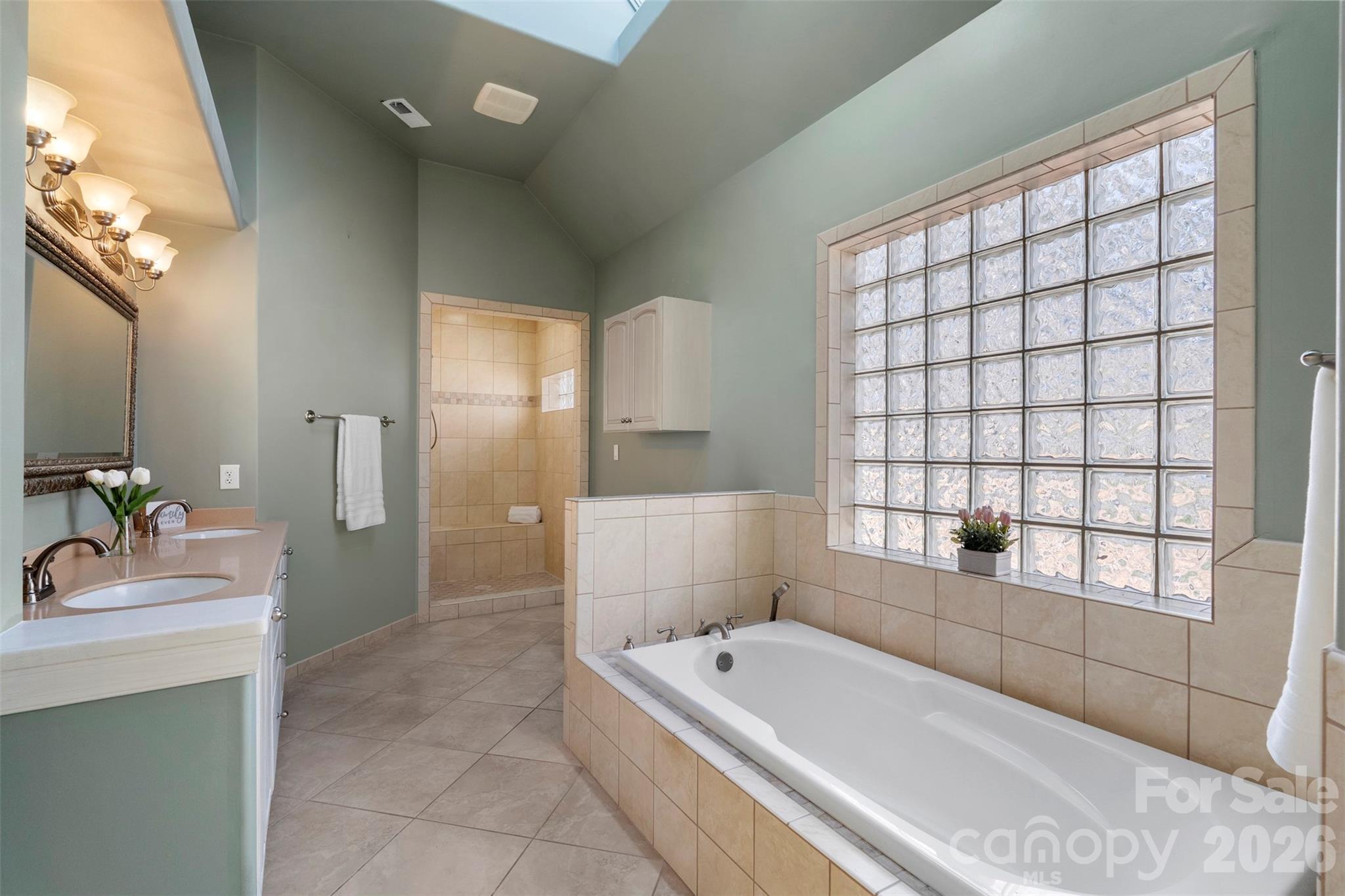 12711 Moores Chapel Road Charlotte, NC 28214 - Photo 24 of 48 a bathroom with a tub sink and mirror