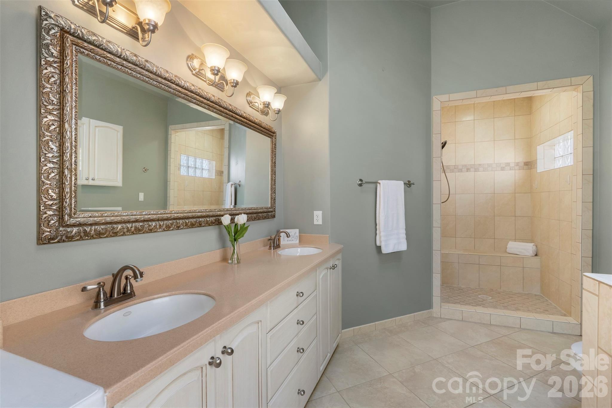 12711 Moores Chapel Road Charlotte, NC 28214 - Photo 27 of 48 a bathroom with a double vanity sink mirror and shower