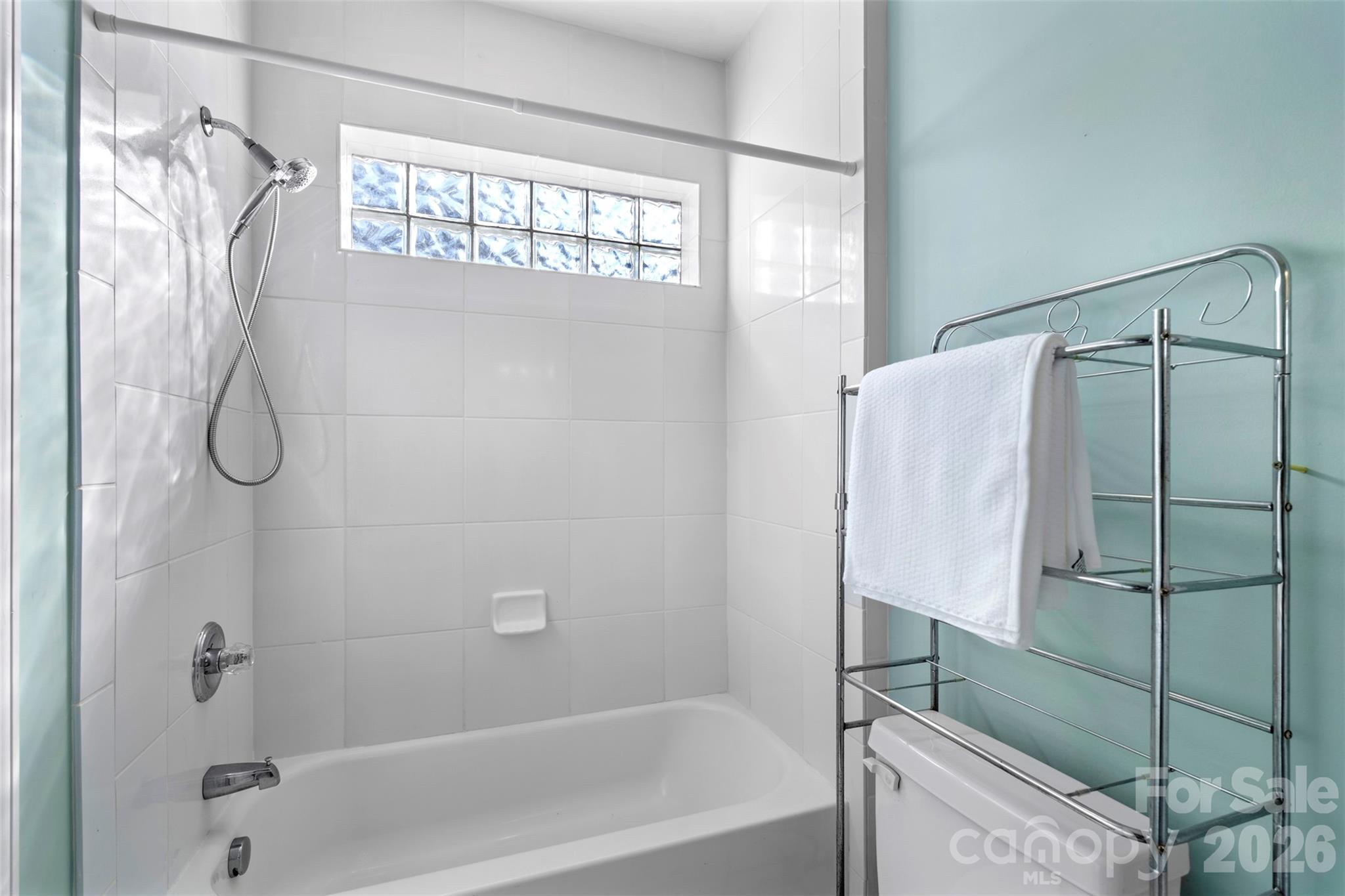 12711 Moores Chapel Road Charlotte, NC 28214 - Photo 31 of 48 a bathroom with a shower and a bathtub