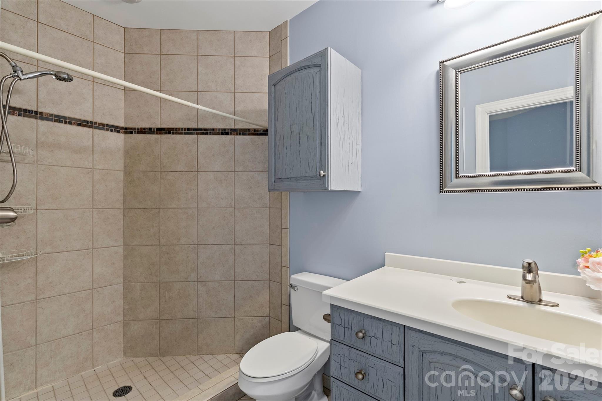 12711 Moores Chapel Road Charlotte, NC 28214 - Photo 33 of 48 a bathroom with a sink a toilet and shower